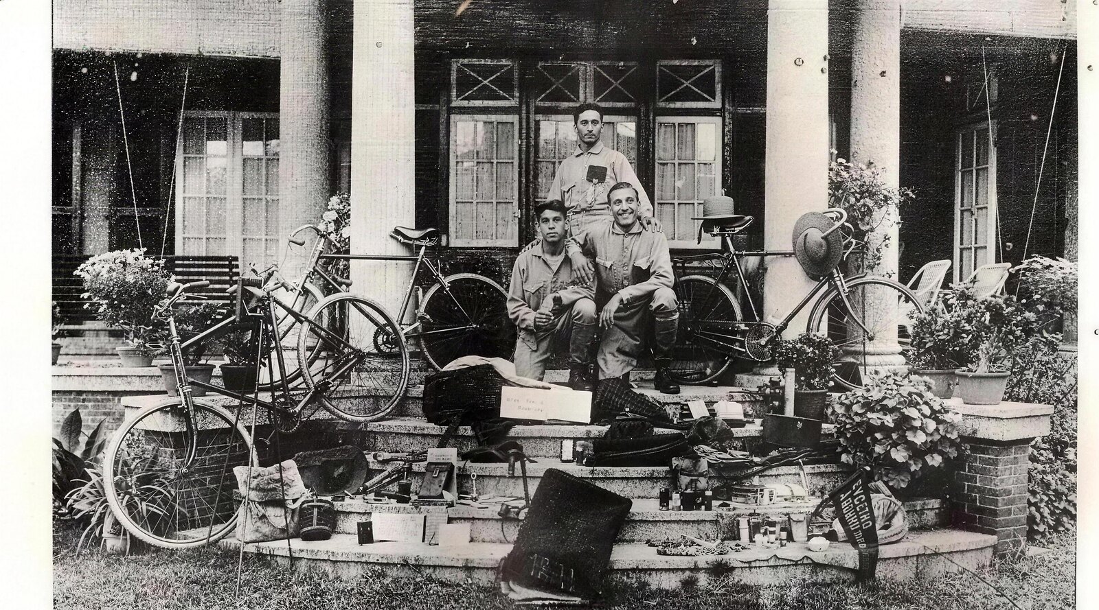 Rustom Bhumgara, Adi Hakim and Jal Bapasola on hotel steps in Alexandria in 1924, their bicycles and all their gear laid out before them