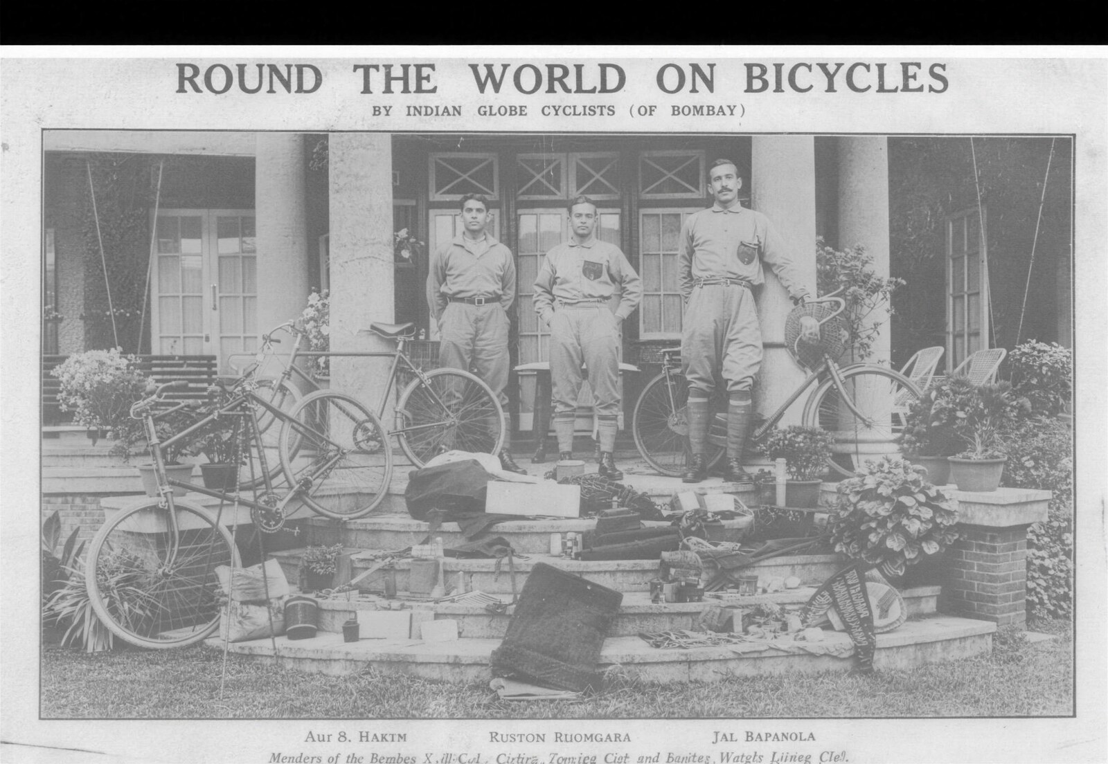 A newspaper plate titled Round the World on Bicycles, the three cyclists standing behind their bicycles with all their gear laid out before them